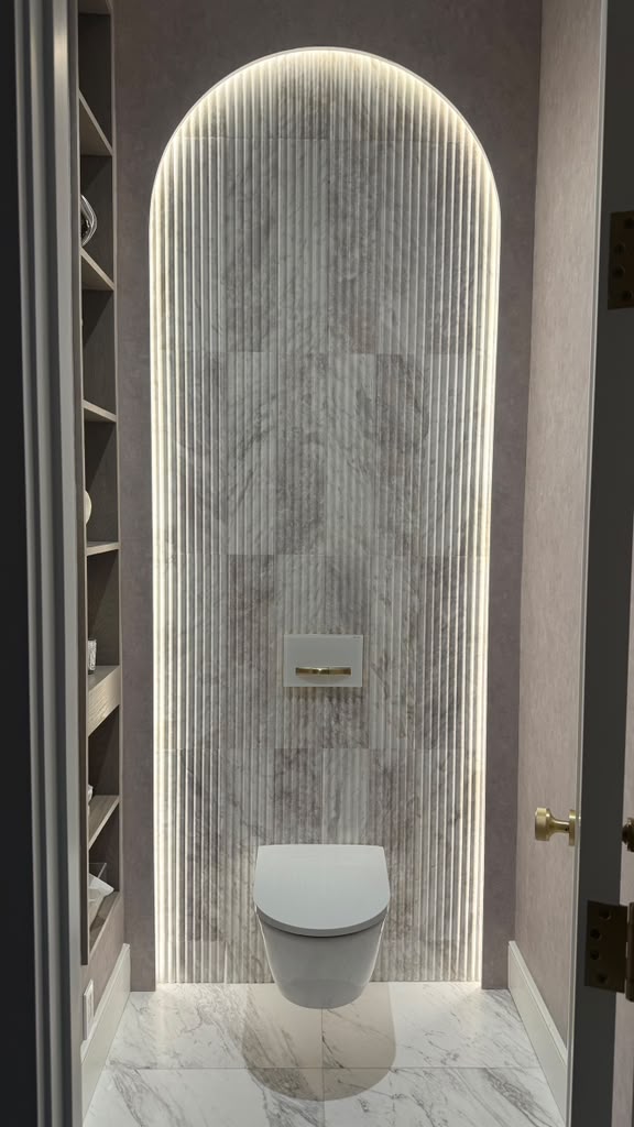 Arched powder room with backlit fluted stone paneling
