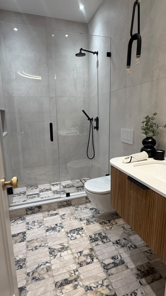 Primary bathroom with matte black fixtures and fluted wood vanity
